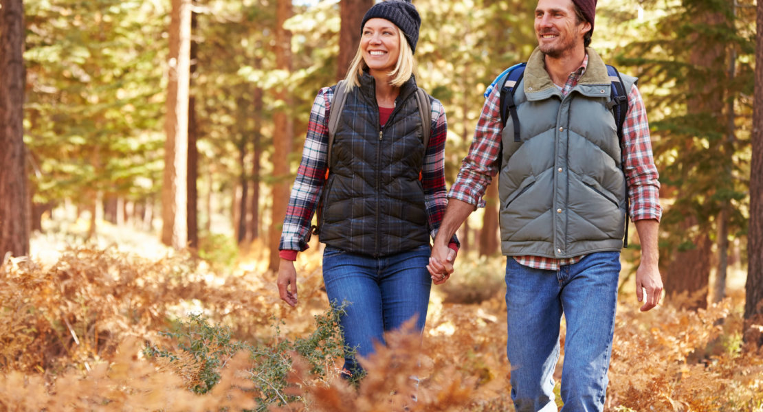 Couple holding hands walking in a forest, California, USA