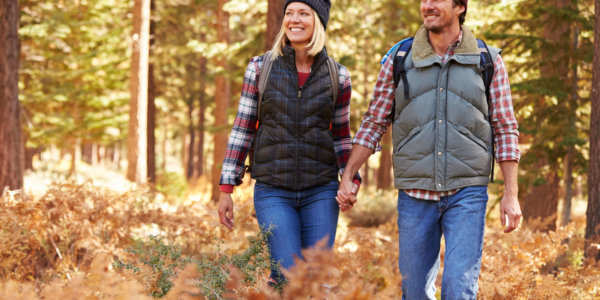 Couple holding hands walking in a forest, California, USA